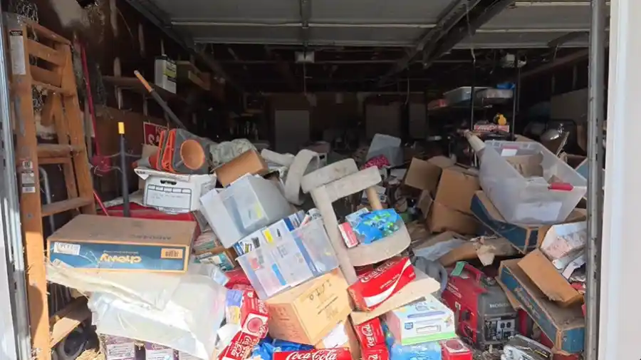 Packed garage full of boxes and clutter before a garage cleanout in Hemet, CA