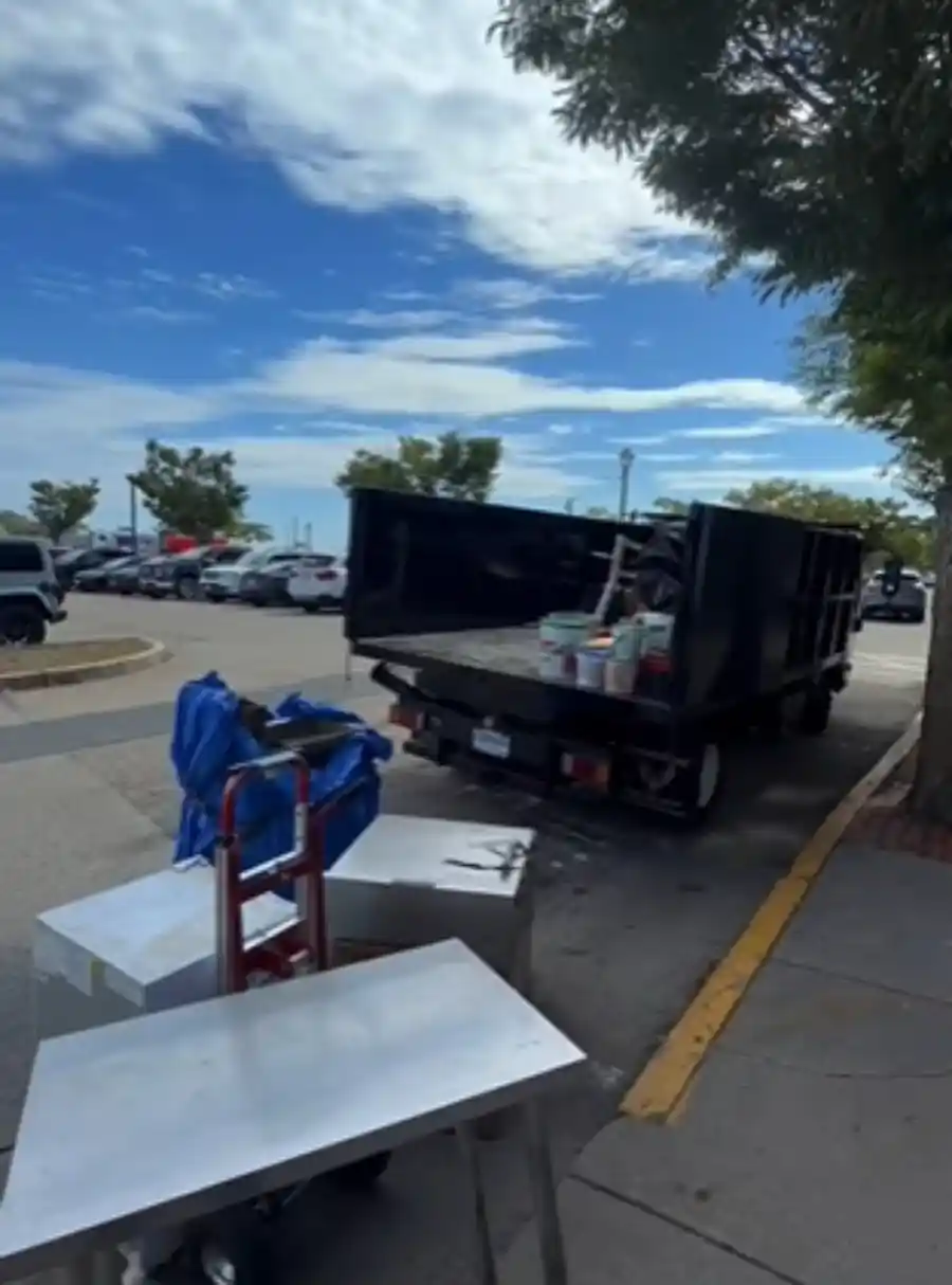Junk removal truck being loaded with furniture during a move out in Hemet, CA